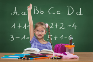 Little girl in the school, and behind the plate letters